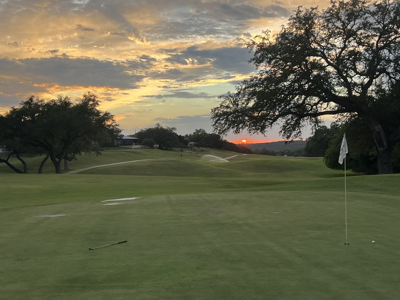 Green and fairway at Lago Vista Golf Course at sunset